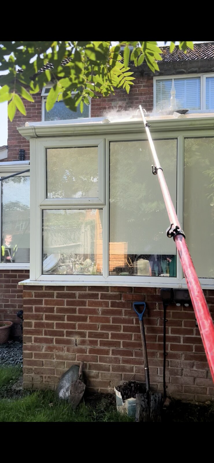 Conservatory glass roof being cleaned