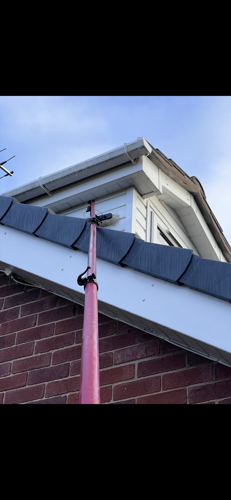 High reach pole cleaning dormer windows and fascia